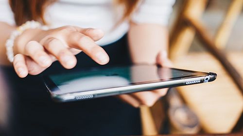 Woman signing e-Consent